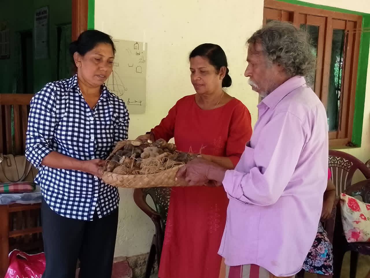 Community farmers receiving yam planting materials and cultivation guidance from CDC