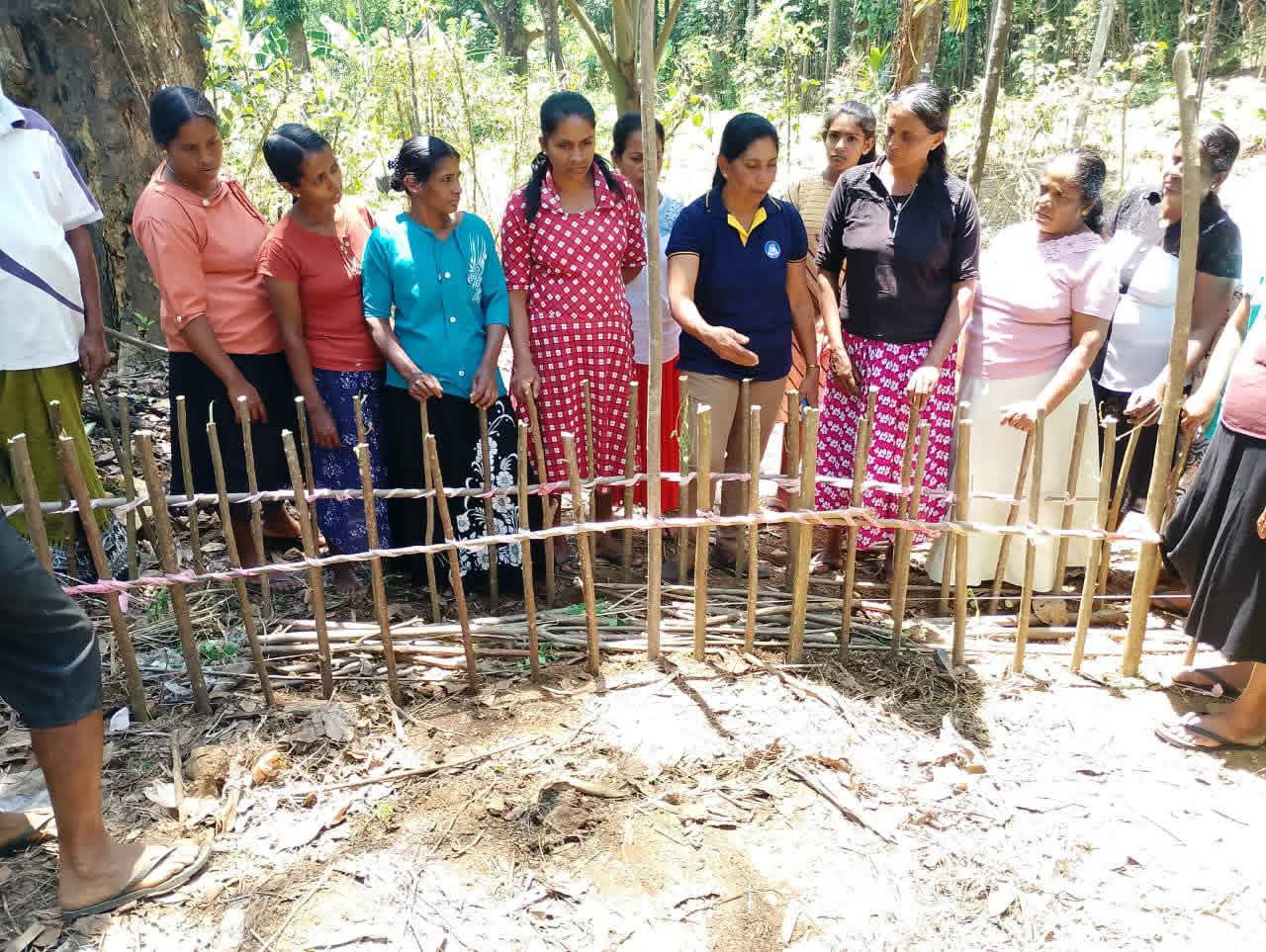 Community members building earth bunds to protect hillside agricultural land from erosion